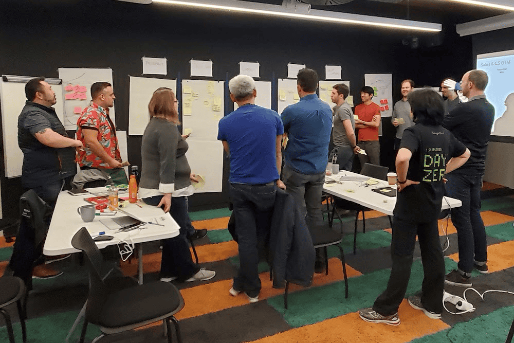 ch-workshop-serv » Chris Hood AI Workshop with Chris Hood, Team brainstorming and collaboration during a corporate workshop or presentation at an office meeting room.